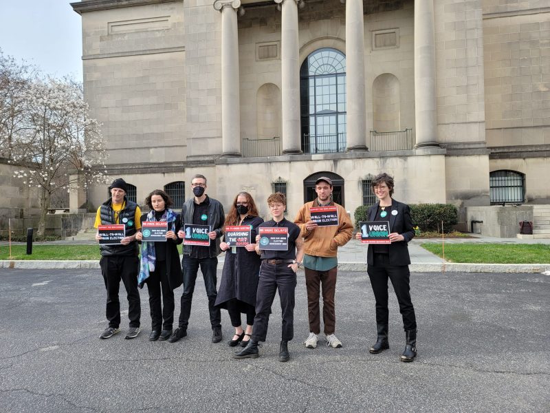 Baltimore Museum of Art workers hold union campaign signs outside the museum entrance on March 22, 2022, during the preview of the "Guarding the Art" exhibition