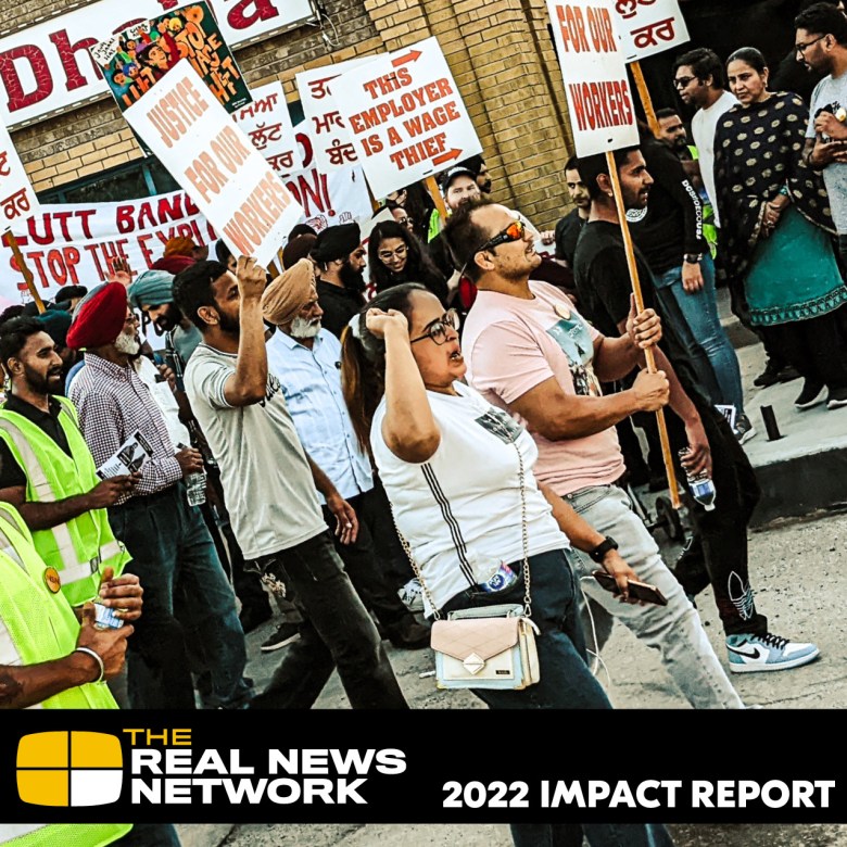 Cover of our 2022 Impact Report, showing workers marching in a protest