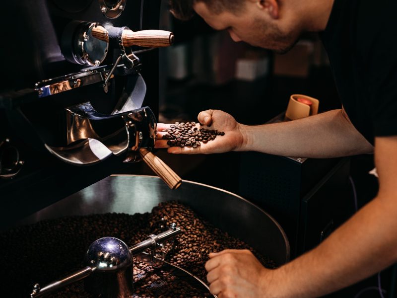Stock image of a young man working in a cafe.