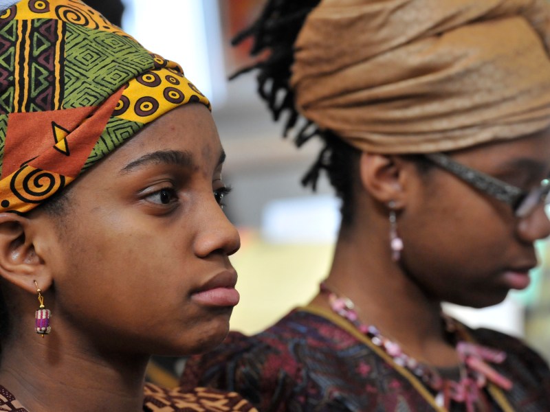 Jocelyn Green (Left) and Shania Alford (Right) listened during the annual Kwanzaa Celebration at the Benjamin Banneker Historical Park and Museum on Dec. 28 in Catonsville, Maryland. The program in it's eighth year celebrates the seven principles of Kwanzaa with performances by the Baltimore County Chapter of Jack and Jill America and the Growing Griots, a youth storytelling program affiliated with the Griots' Circle of Maryland.