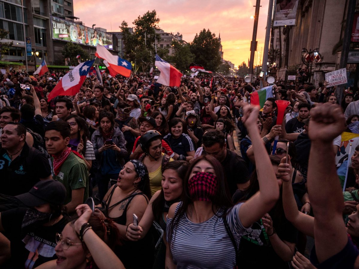 Demonstrators gather in Santiago, on October 25, 2019, a week after protests started. Demonstrations against a hike in metro ticket prices in Chile's capital exploded into violence on October 18, unleashing widening protests over living costs and social inequality. Photo by PEDRO UGARTE/AFP via Getty Images