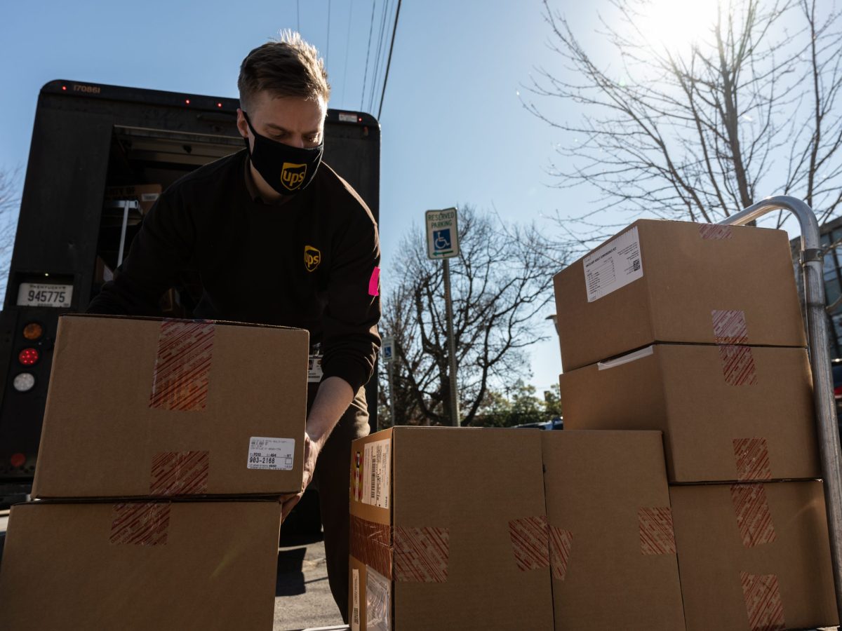 Adam Dentinger, a UPS delivery driver, unloads a shipment of Janssen COVID-19 vaccines and ancillary kits at Louisville Metro Health and Wellness headquarters on March 4, 2021 in Louisville, Kentucky. Photo by Jon Cherry/Getty Images