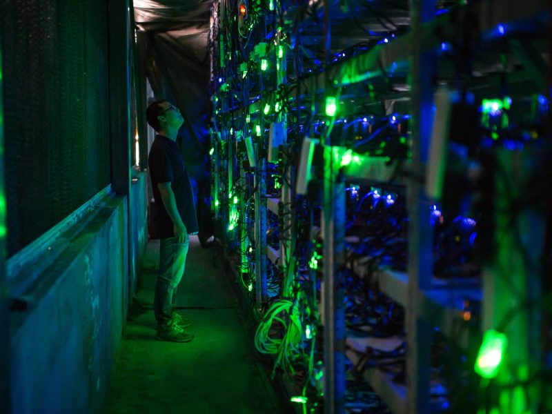 Haobtc's bitcoin mine site manager, Guo-hua, checks mining equipment inside their bitcoin mine near Kongyuxiang, Sichuan, China. Photo by Paul Ratje/For The Washington Post via Getty Images