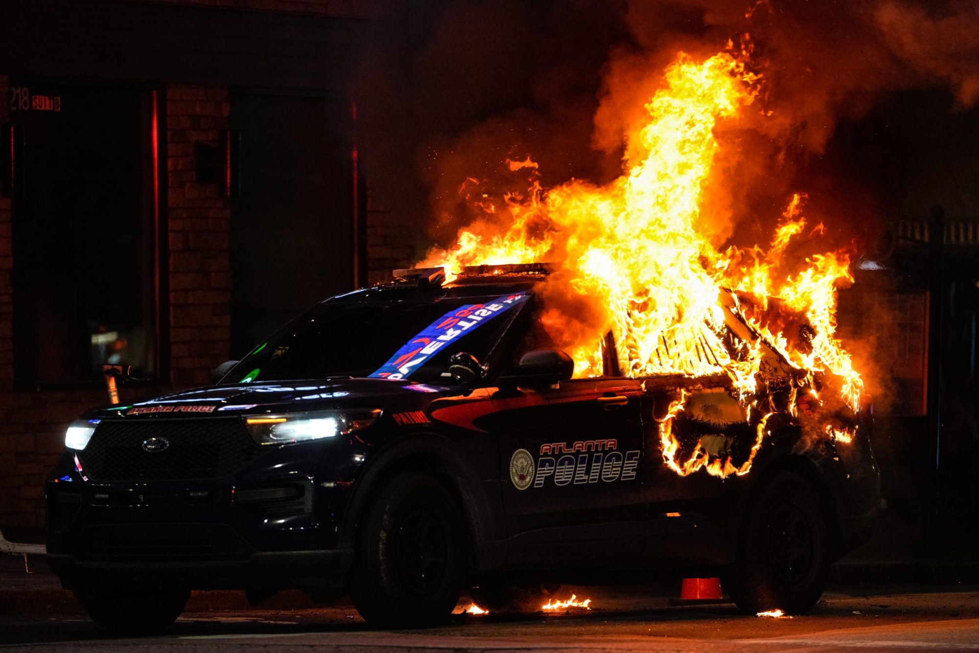 An Atlanta police vehicle is set on fire during a "Stop cop city" protest in Atlanta, Georgia, United States on January 21, 2023. Photo by Benjamin Hendren/Anadolu Agency via Getty Images
