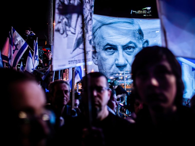 Israeli anti-reform protesters stand under a photo of Israeli Prime Minister Benjamin Netanyahu during an anti-reform demonstration. Photo by Eyal Warshavsky/SOPA Images/LightRocket via Getty Images