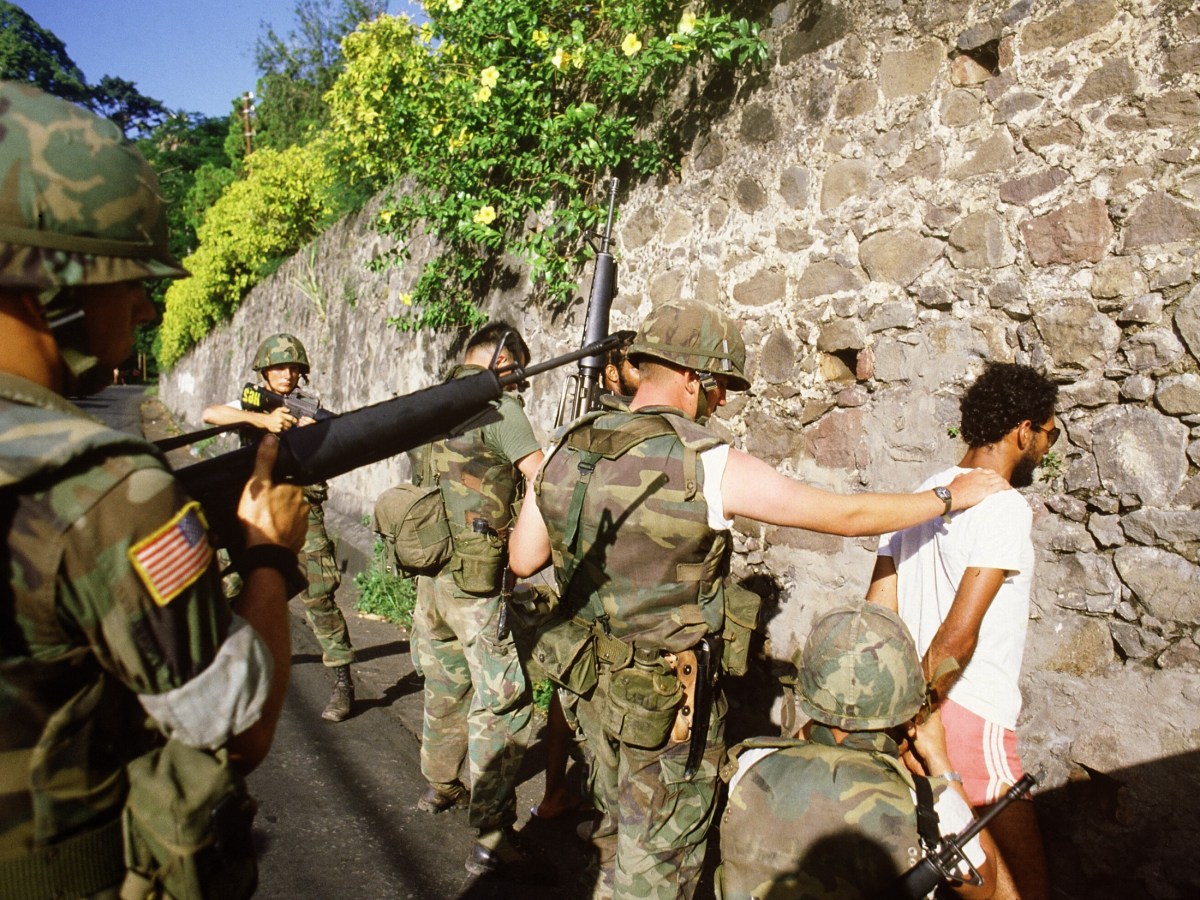 US soldiers arrest 30 October 1983 suspected Marxist activist in St George's, the capital of the Grenada Island, three days after US troops, including 800 Marines, invaded the island 27 October, ousting the Marxist government. Photo by -/AFP via Getty Images