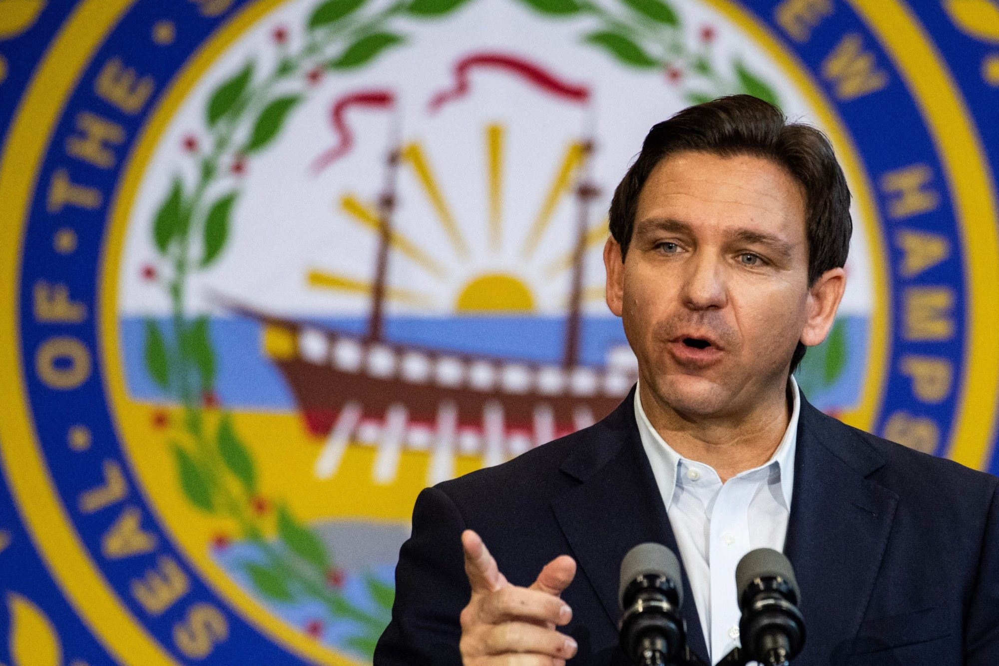 Gov. Ron DeSantis delivers a statement in front of a large Florida State Seal.