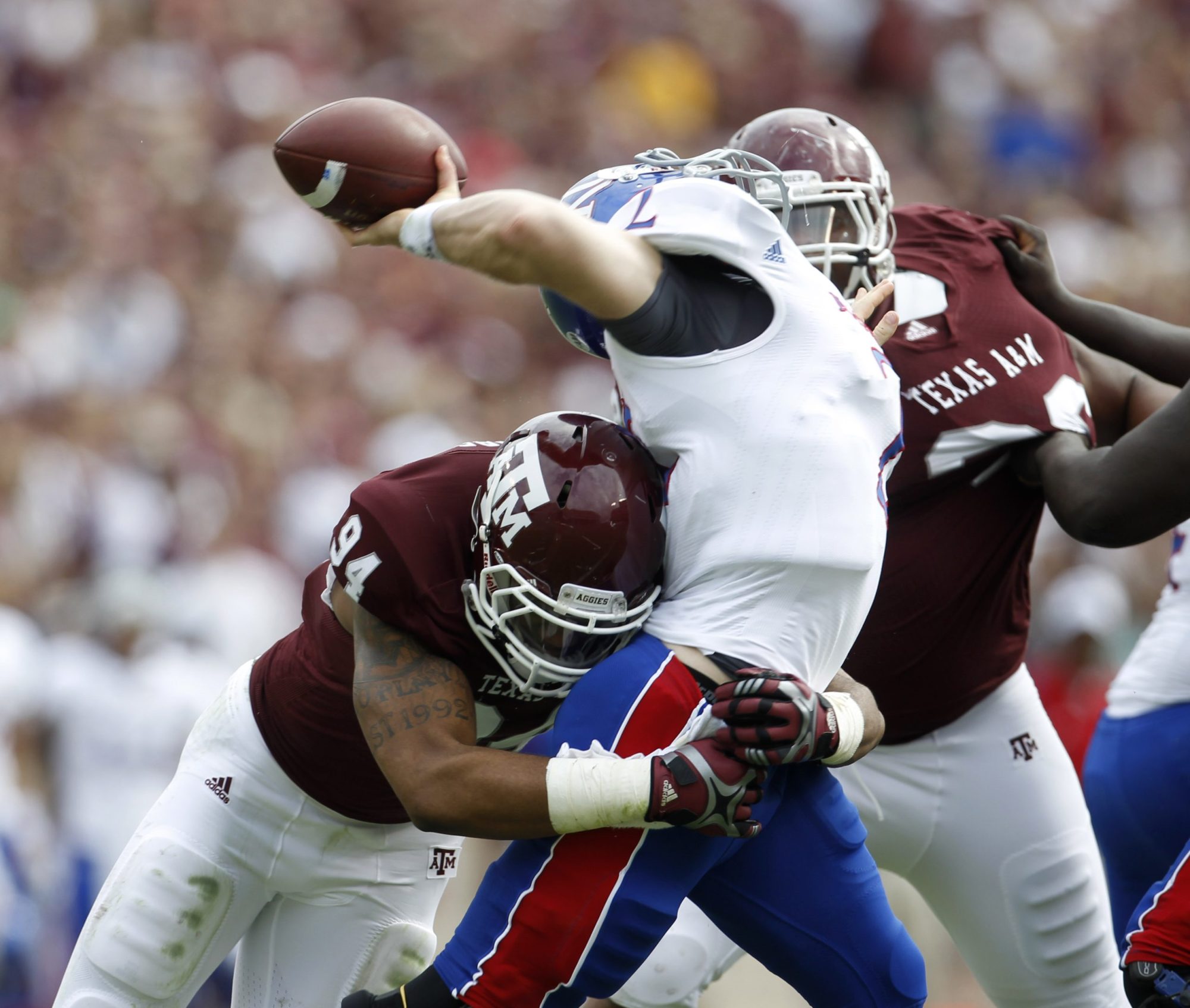Kansas QB Jordan Webb (2) is sacked by Texas A&M Aggies linebacker Damontre Moore (94) and was off the field with an injury after getting sacked during the first half of the college football game at Texas A&M, Nov. 19, 2011. Photo by Karen Warren/Houston Chronicle via Getty Images