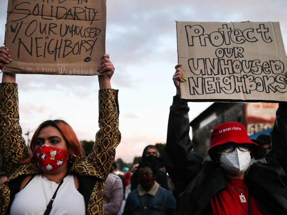 Protesters demonstrate on Sunset Boulevard against the removal of a homeless encampment at Echo Park Lake on March 25, 2021 in Los Angeles, California. Photo by Mario Tama/Getty Images