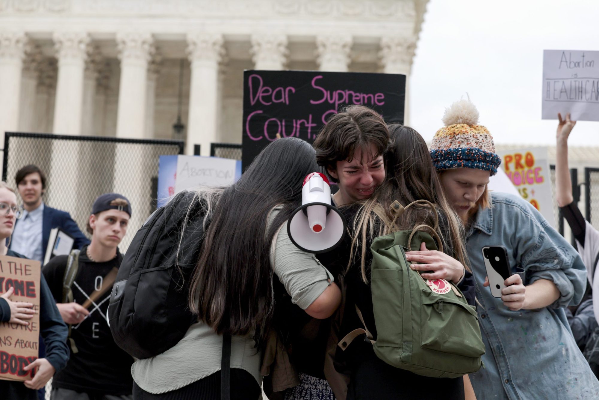 Hannah Yost is embraced by her husband and fellow protesters as she speaks about her experience with sexual assault during an abortion-rights rally in front of the U.S. Supreme Court building on May 05, 2022 in Washington, DC. Photo by Anna Moneymaker/Getty Images