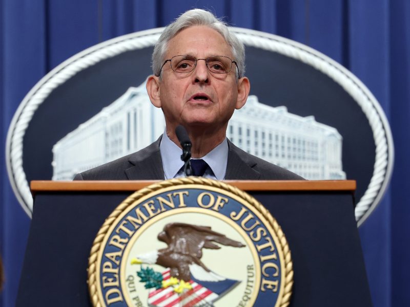 Merrick Garland stands at a White House podium and delivers an address.