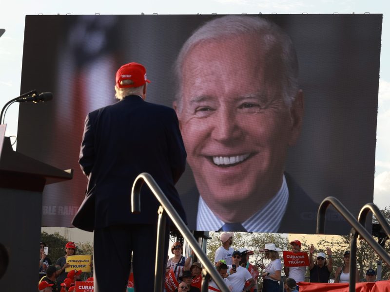 Former U.S. President Donald Trump watches a video of President Joe Biden playing during a rally for Sen. Marco Rubio (R-FL) at the Miami-Dade Country Fair and Exposition on November 6, 2022 in Miami, Florida. Photo by Joe Raedle/Getty Images