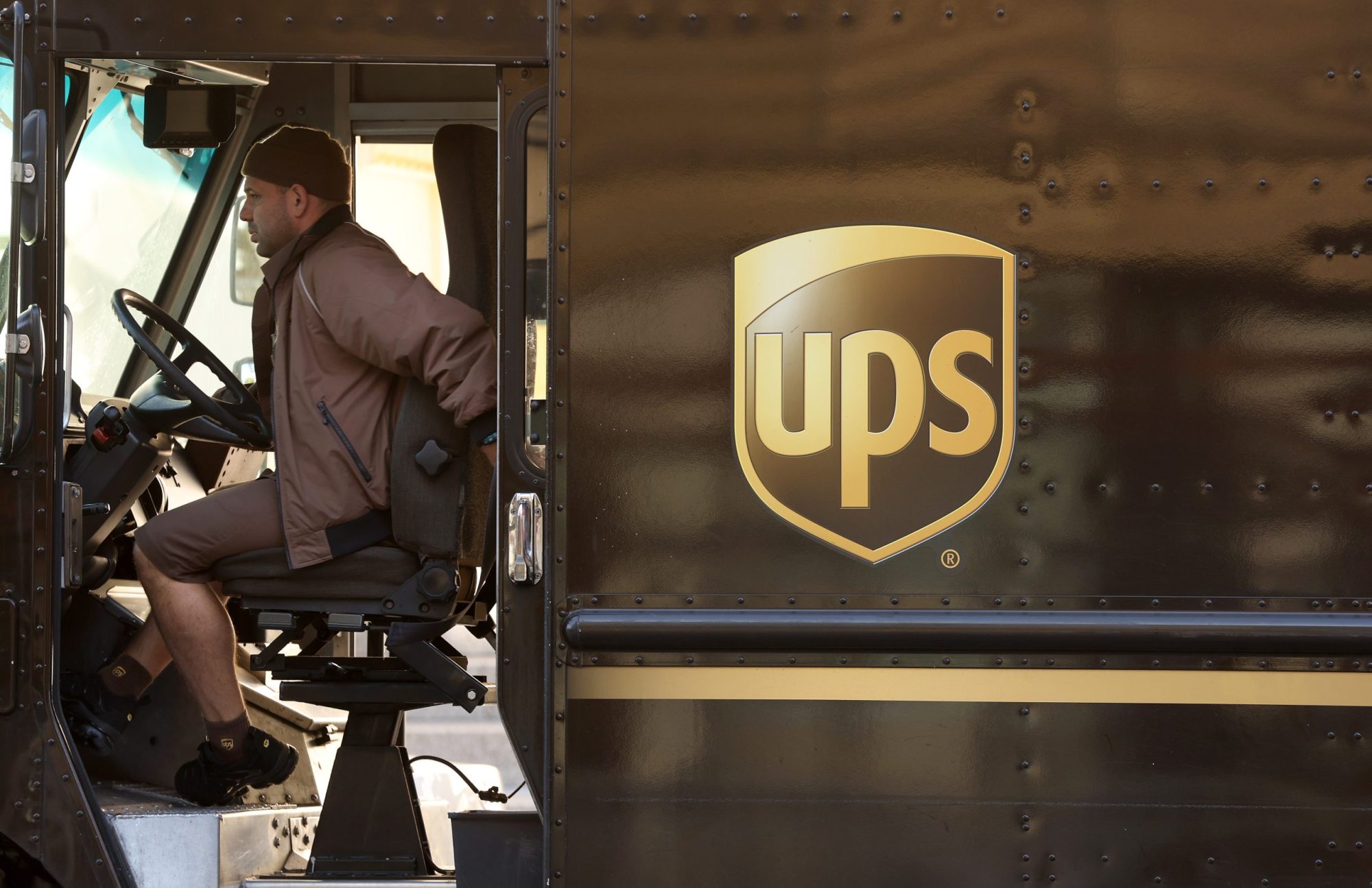 A United Parcel Service (UPS) driver sits in his delivery truck on Jan. 31, 2023, in San Francisco, California.