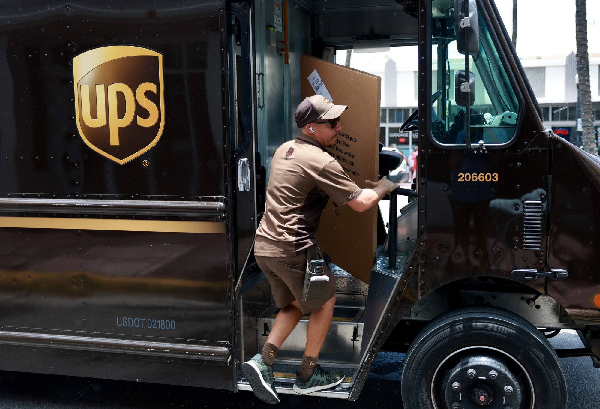 A UPS driver makes a delivery on June 30, 2023 in Miami, Florida. Photo by Joe Raedle/Getty Images