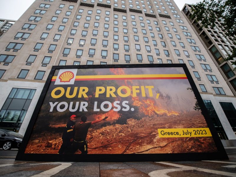 Greenpeace activists hold a billboard during a protest outside Shell headquarters amid the companies profits announcement on July 27, 2023 in London, England. Photo by Handout/Chris J Ratcliffe for Greenpeace via Getty Images