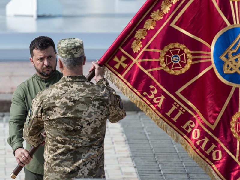 Ukrainian President Volodymyr Zelensky hands over a flag to a member of the Ukrainian military serviceman during an official ceremony on August 24, 2023 in Kyiv, Ukraine. Photo by Alexey Furman/Getty Images