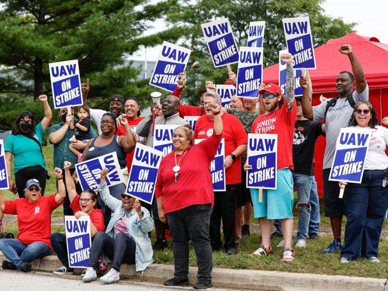 UAW members and workers at the Mopar Parts Center Line, a Stellantis Parts Distribution Center in Center Line, Michigan, hold signs outside the facility after walking off their jobs at noon on September 22, 2023. Photo by KAMIL KRZACZYNSKI/AFP via Getty Images