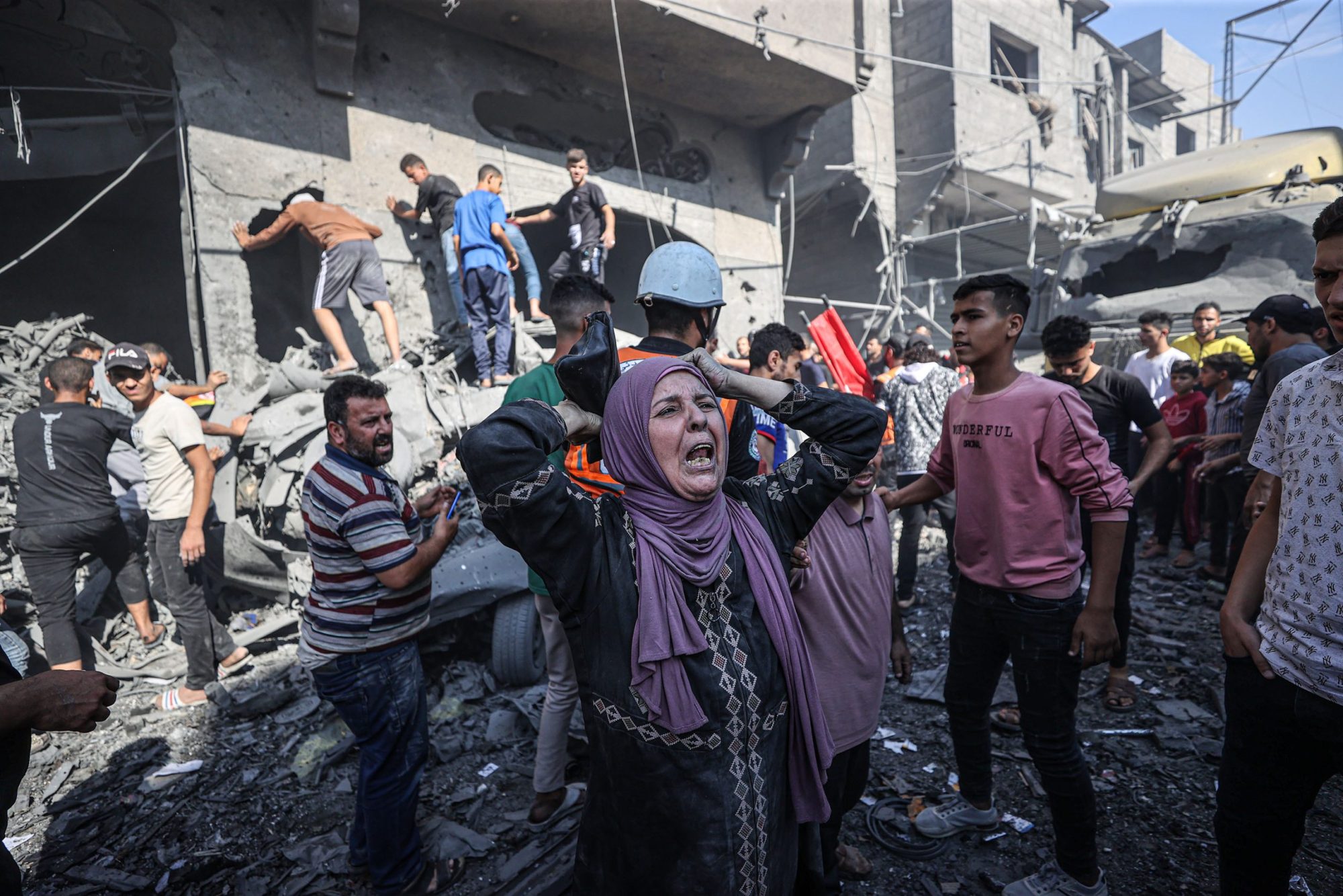 Civil defense teams and residents launch a search and rescue operation around the buildings that were destroyed after Israel's attacks on the Gaza Strip on its eleventh day in Khan Yunis, Gaza on October 17, 2023. Photo by Mustafa Hassona/Anadolu via Getty Images