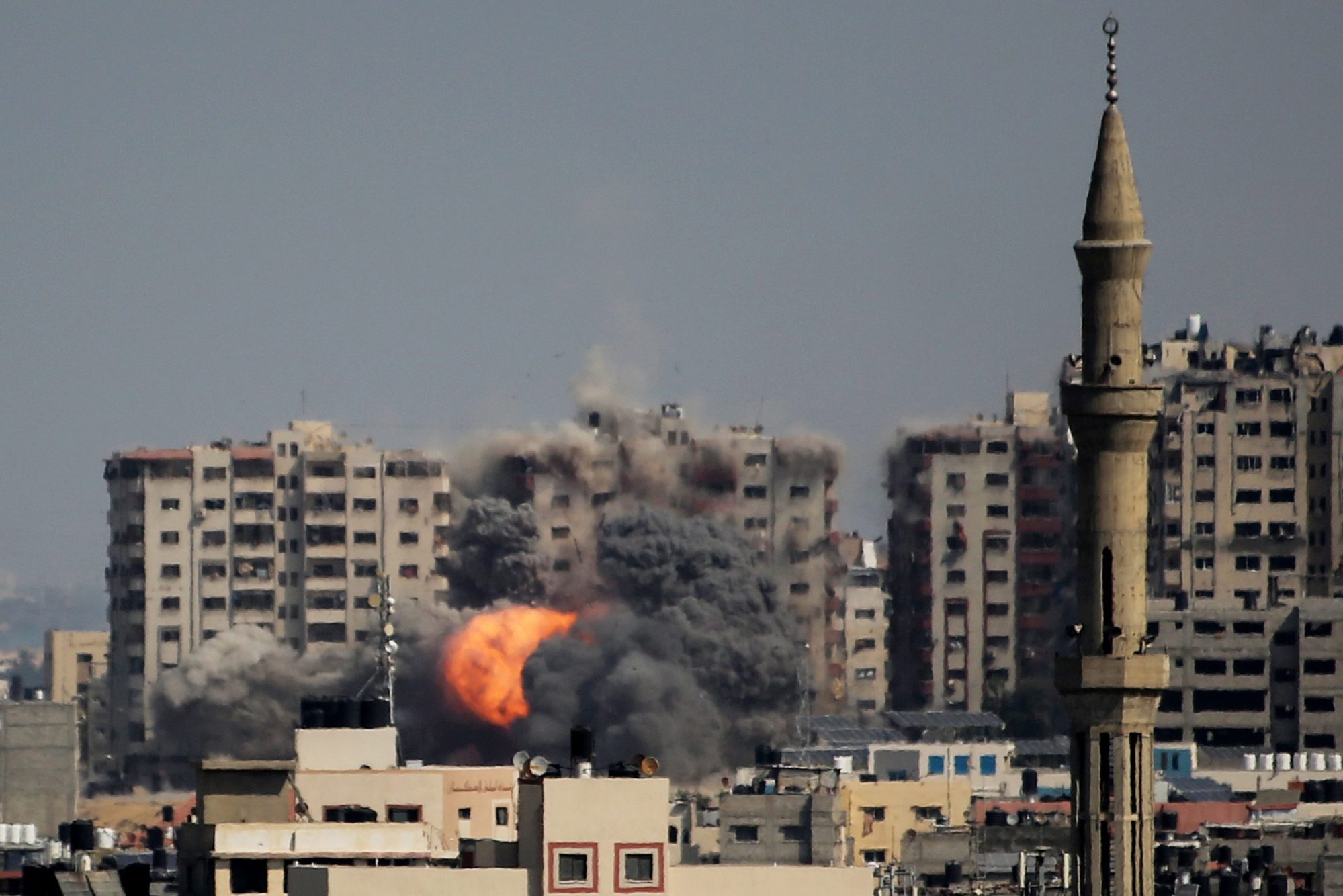 An explosion on a residential tower caused by Israeli raids in the northern Gaza Strip on October 12, 2023 in Gaza City, Gaza. Photo by Ahmad Hasaballah/Getty Images