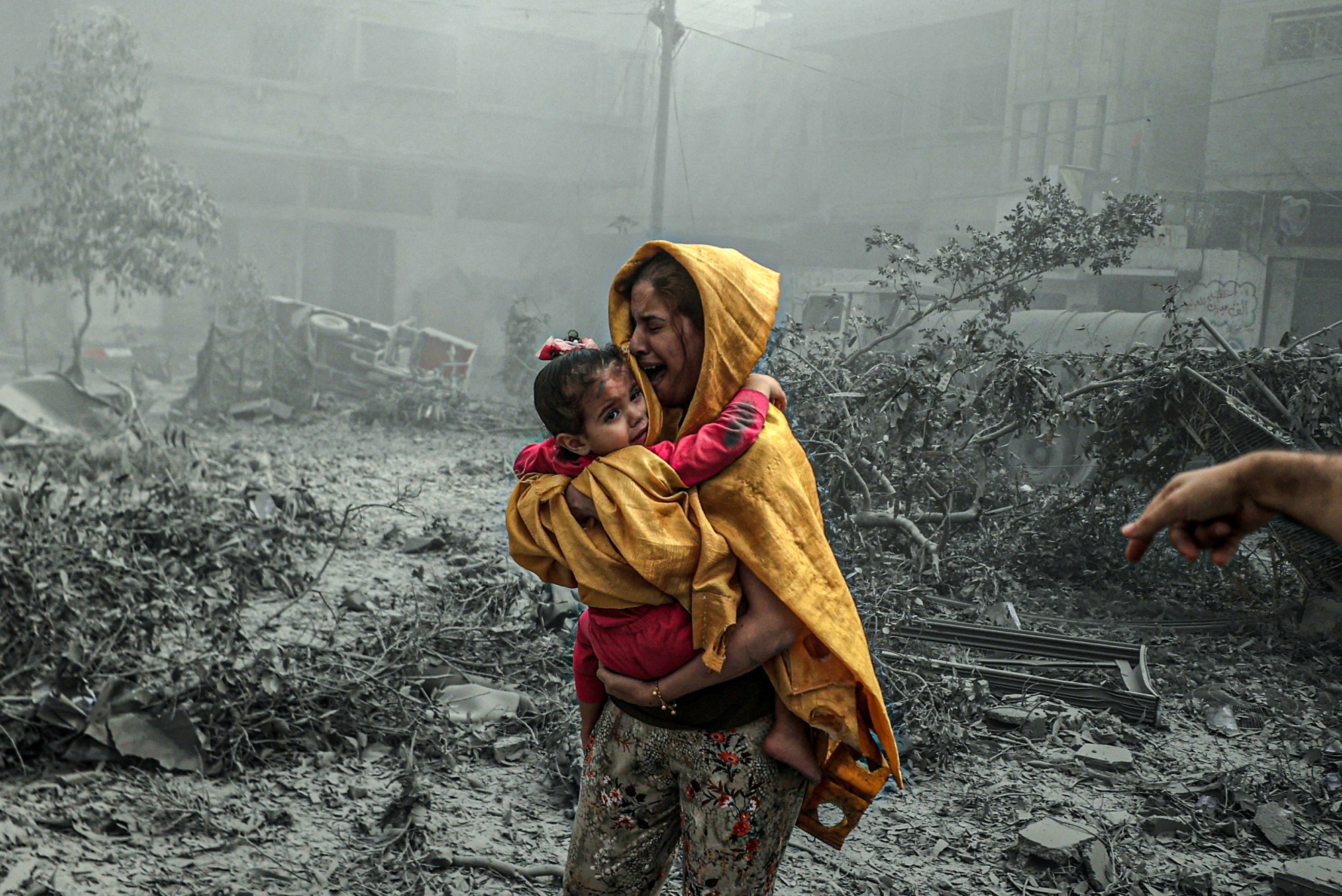 A woman holding a girl reacts after Israeli airstrikes hit Ridwan neighborhood of Gaza City, Gaza on October 23, 2023. Photo by Ali Jadallah/Anadolu via Getty Images