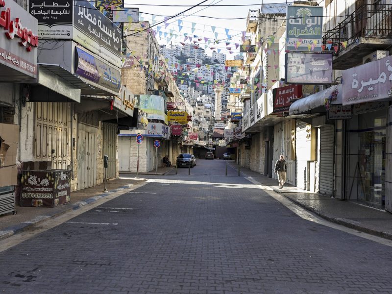 A picture shows shuttered shops on an empty street during a general strike in solidarity with Gaza in the occupied West Bank city of Nablus on December 11, 2023. Photo by ZAIN JAAFAR/AFP via Getty Images