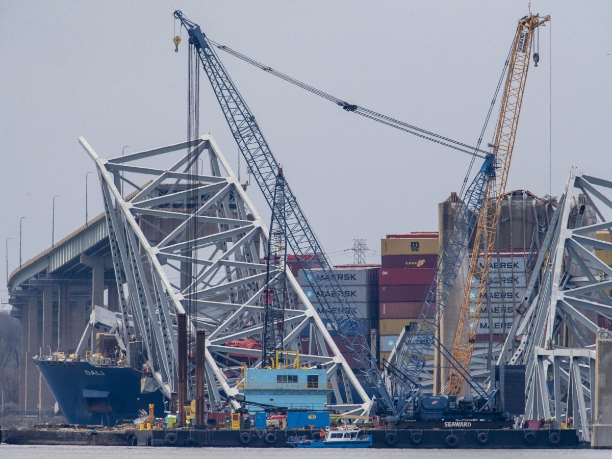 Workers start to clear the channel of the twisted metal and concrete of the Francis Scott Key Bridge, as authorities turn their focus to "salvage" operations with heavy duty cranes to remove wreckage from the Patapsco River after the massive container ship, Dali, caused Baltimore's Key Bridge to collapse on March 30, 2024. Photo by Jonathan Newton/for The Washington Post via Getty Images