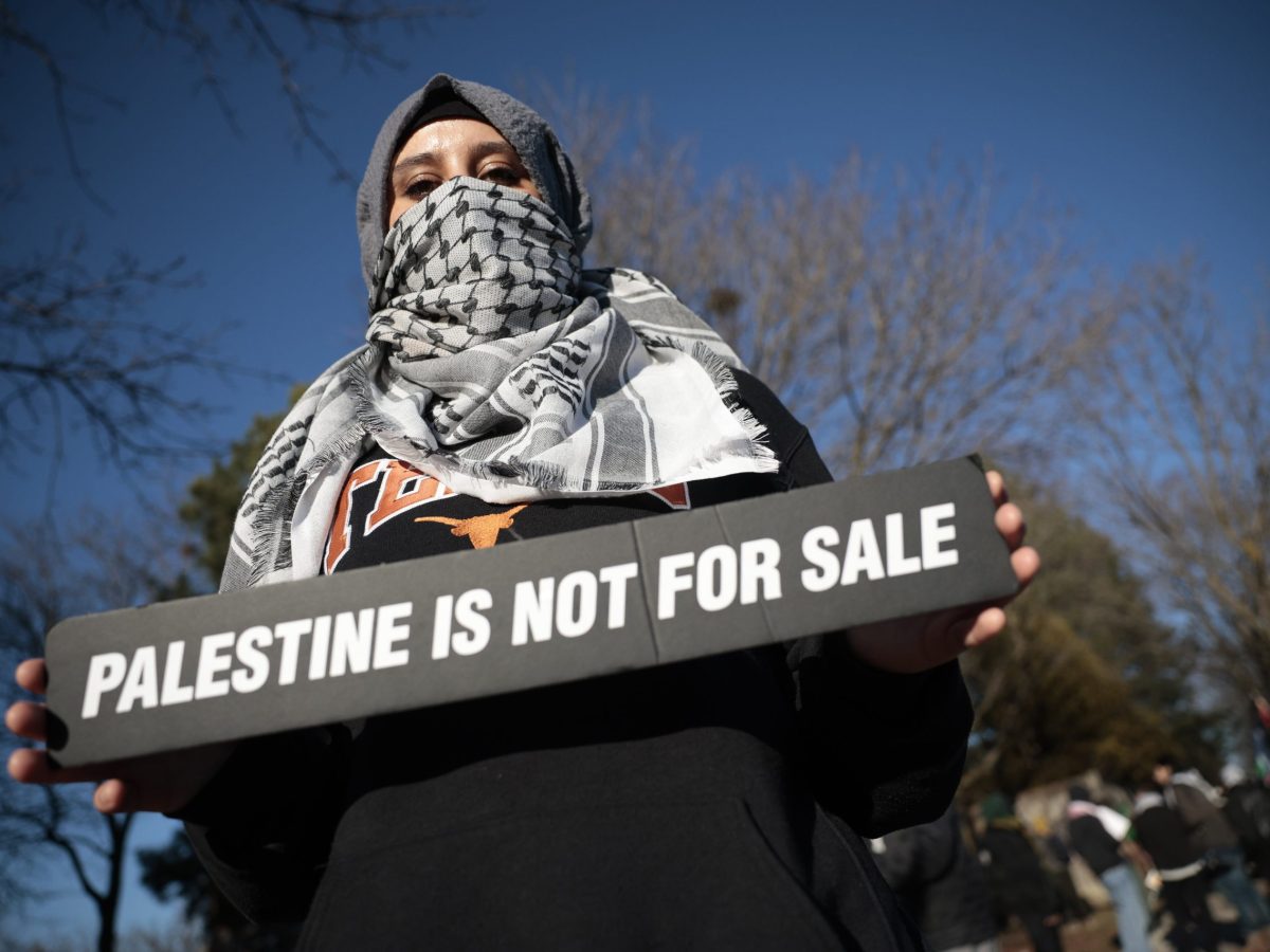 Youthful Protester for Palestine holds a sign saying "Palestine is not for sale"Protest at BAYT synagogue over it hosting a real estate event showcasing land in illegal West Bank settlements. R.J. Johnston/Toronto Star via Getty Images