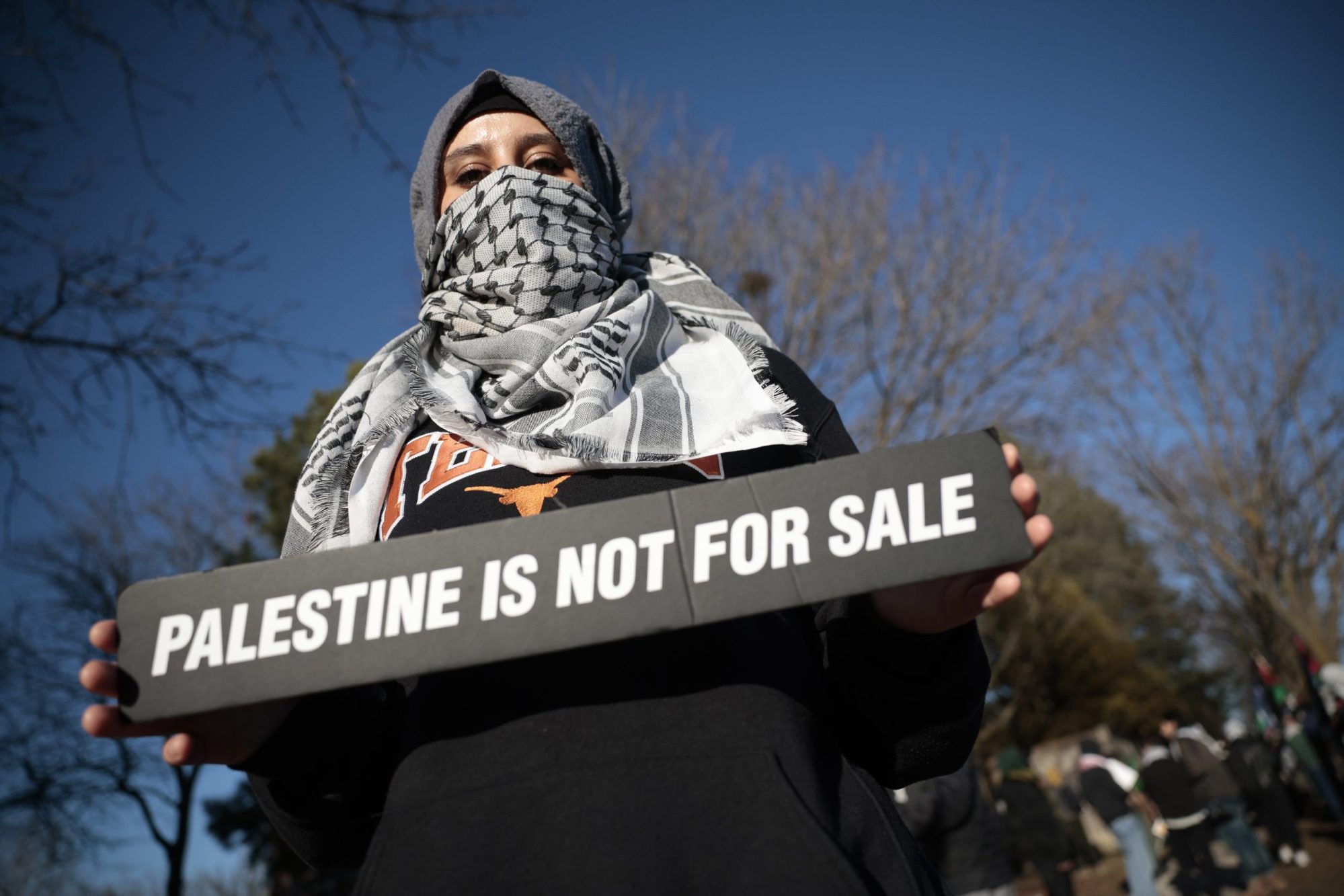 Youthful Protester for Palestine holds a sign saying "Palestine is not for sale"Protest at BAYT synagogue over it hosting a real estate event showcasing land in illegal West Bank settlements. R.J. Johnston/Toronto Star via Getty Images