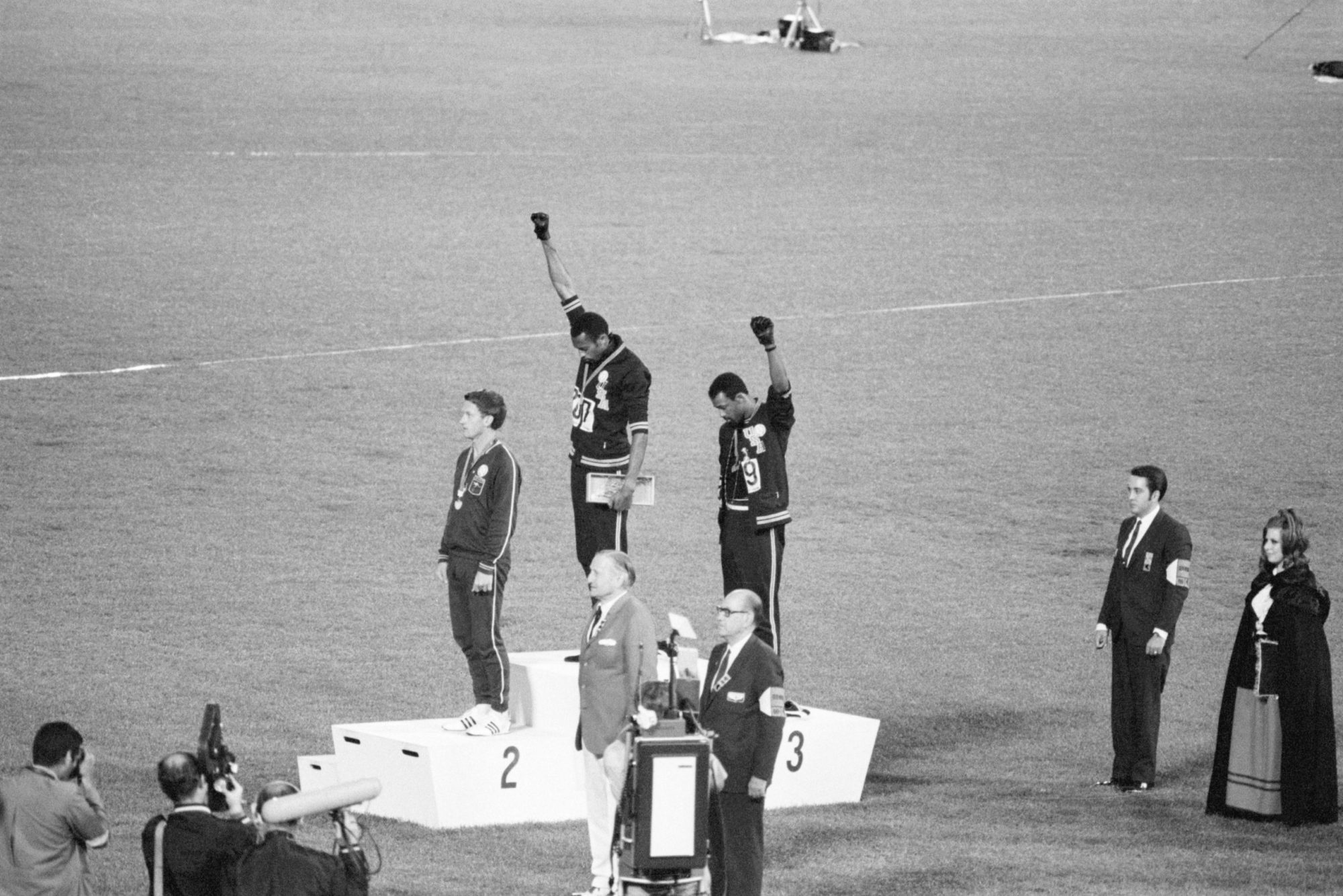Tommie Smith and John Carlos, gold and bronze medalists in the 200-meter run at the 1968 Olympic Games, engage in a victory stand protest against unfair treatment of blacks in the United States.