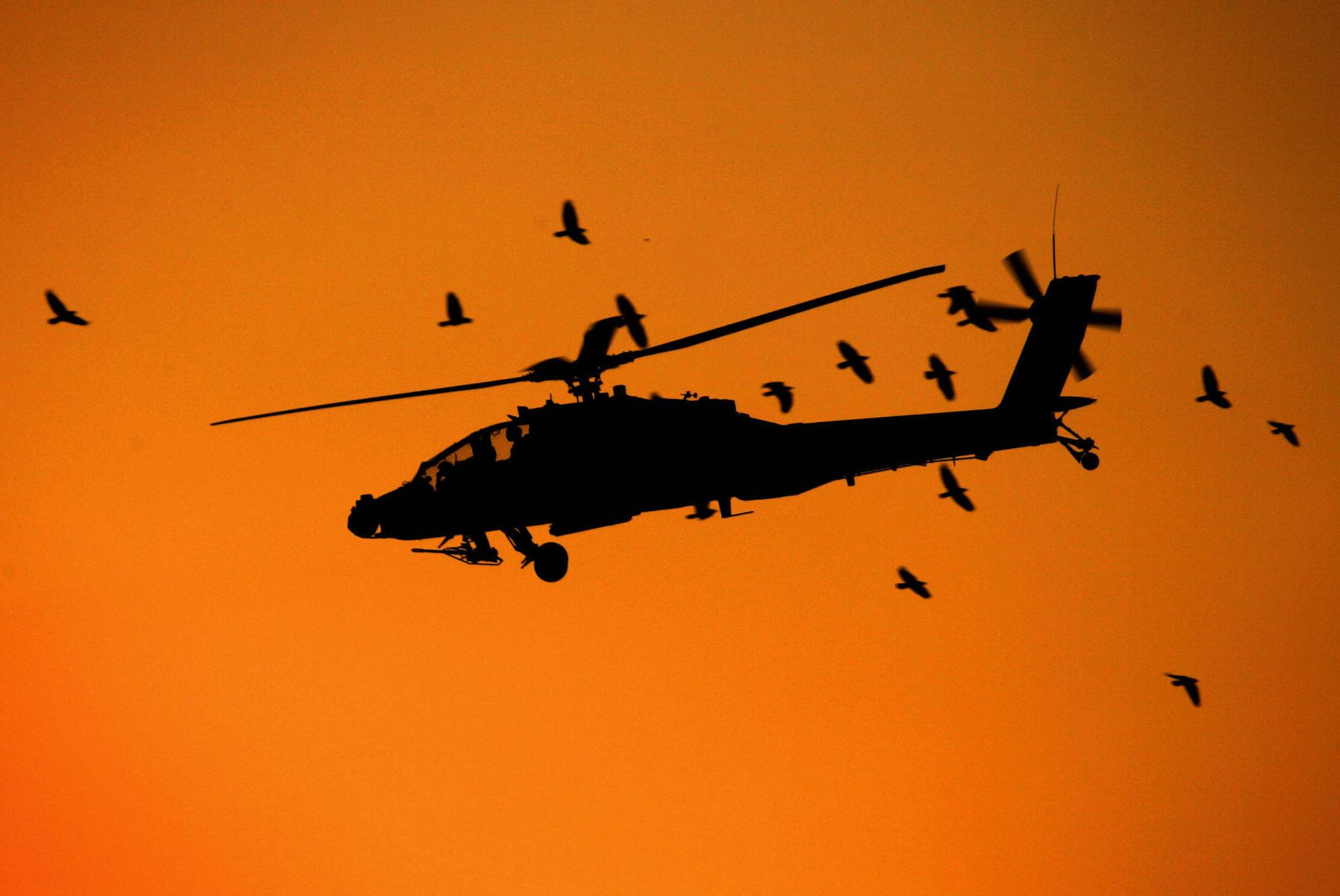 A US military Apache helicopter flies over western Baghdad, 28 October, 2005. DAVID FURST/AFP via Getty Images
