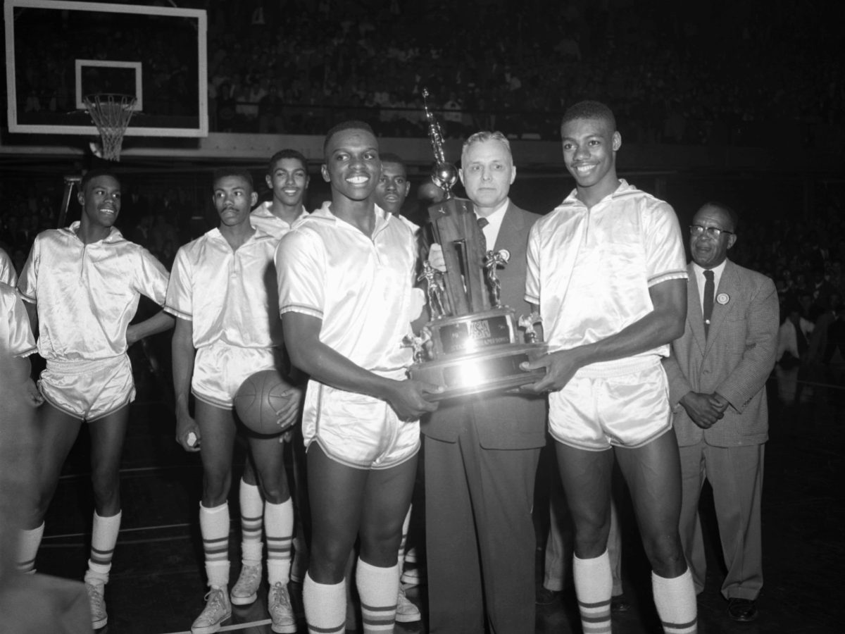 Members of the Crispus Attucks Tigers accept the 1956 Indiana State High School Boys Basketball Championship trophy after the game in March, 1956 against the Lafayette Jefferson Bronchos in March, 1956 at the Butler Fieldhouse in Indianapolis, Indiana. Photo by:Diamond Images/Getty Images
