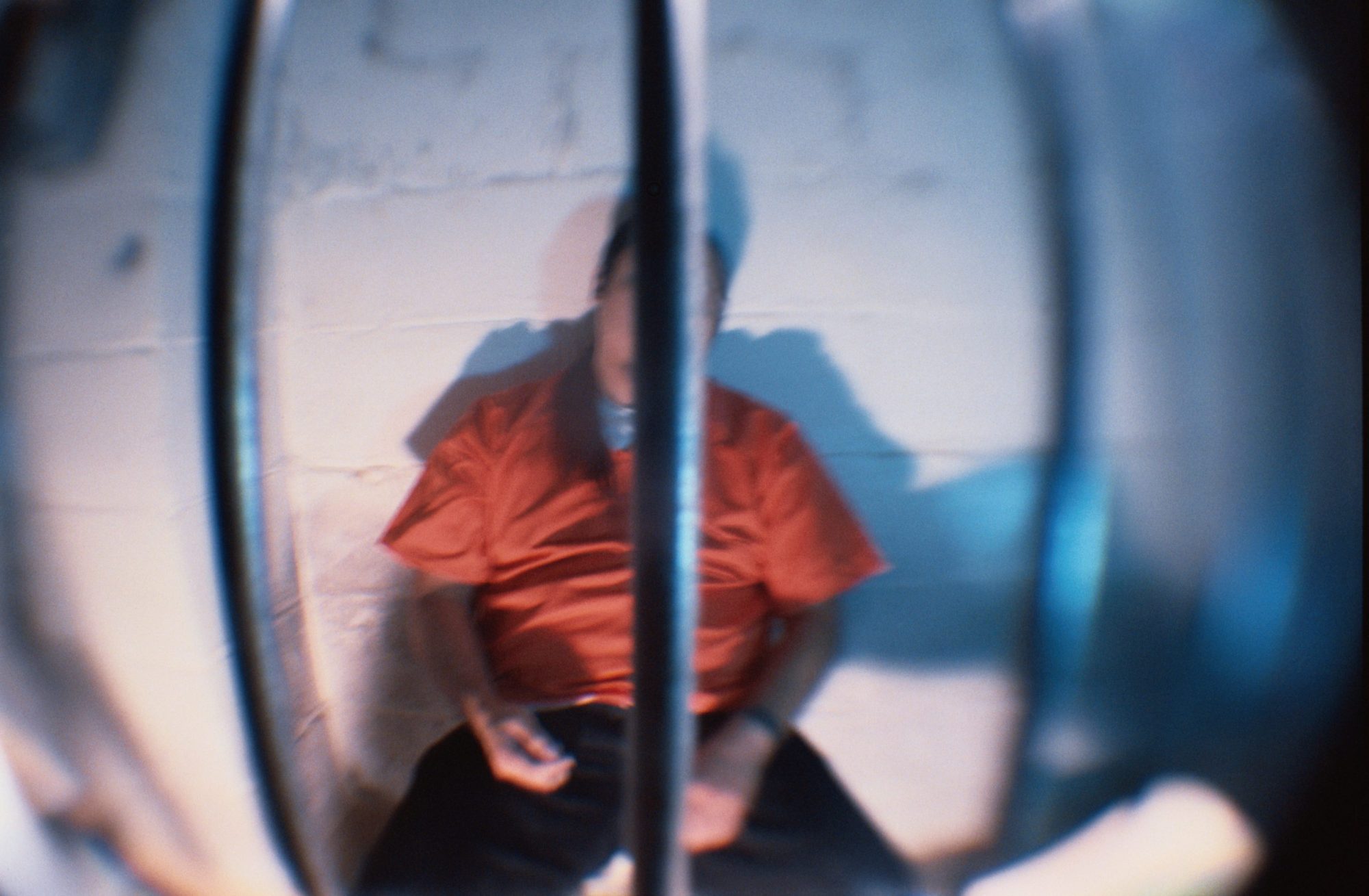 Prisoner Behind Bars of Cell. Photo by Steven Puetzer via Getty Images