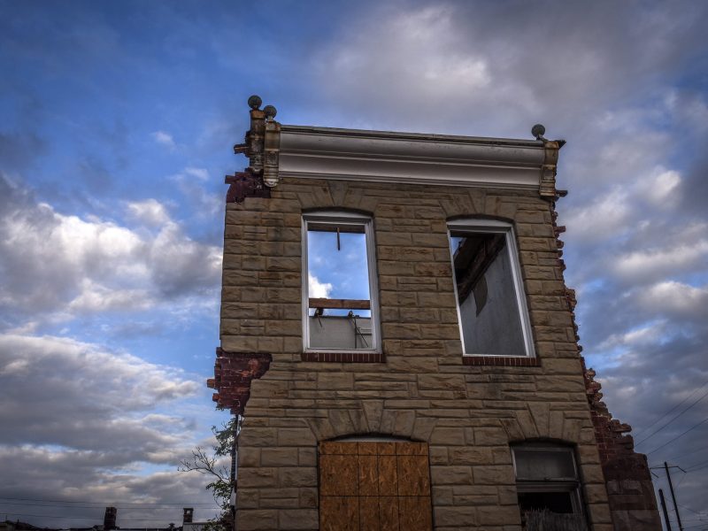 front of a heavily damaged brick building