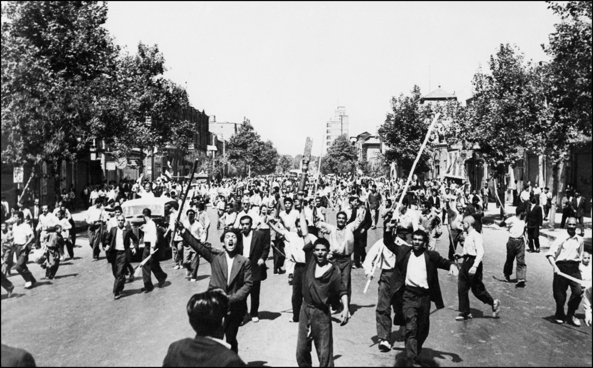 Rioters armed with staves shout slogans, during riots in Tehran, August 1953. Photo by -/INTERCONTINENTALE/AFP via Getty Images