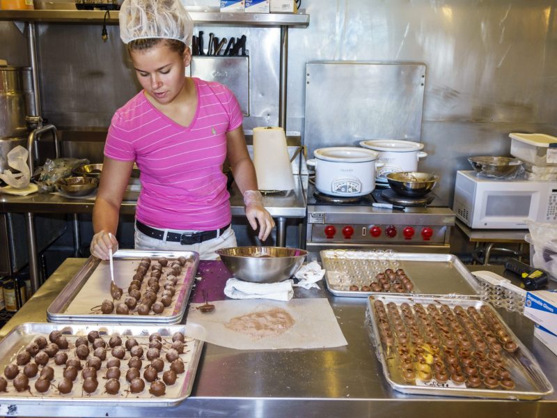 A teen girl working at Pat and Toni's Chocolate and Sweet Things. Photo by: Jeffrey Greenberg/Universal Images Group via Getty Images
