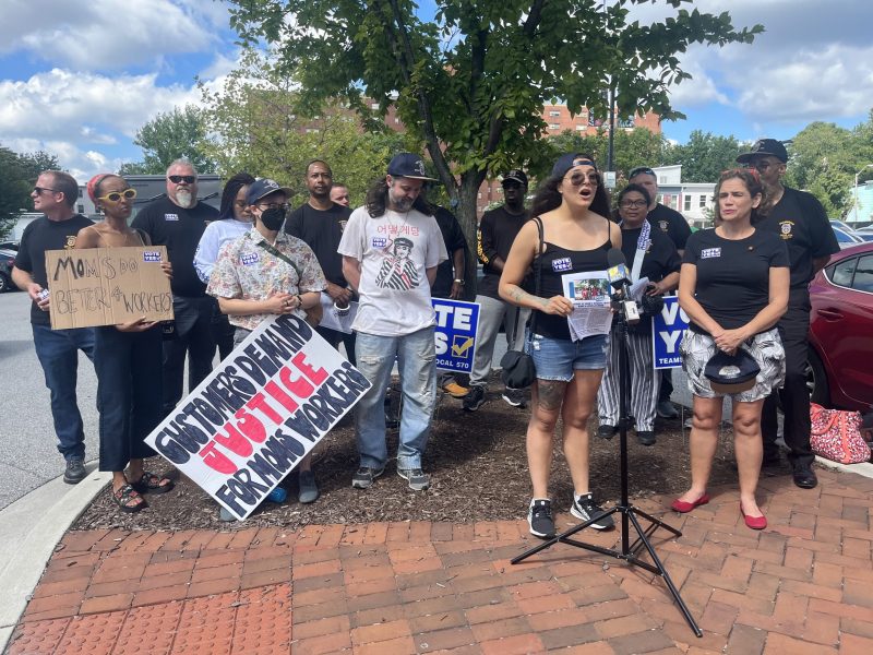 MOM's Organic Market worker Natalia De Oliveira speaks at a rally in support of workers at the MOM's store in Baltimore's Hampden neighborhood on Tuesday, Aug. 23, 2022.