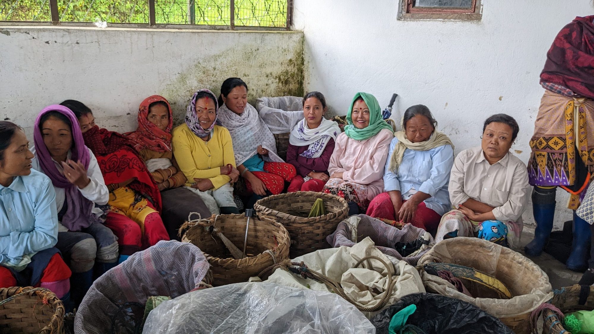 A group of women tea workers sit together around their tea baskets during a work stoppage at the Happy Valley Tea Estate in Darjeeling, India, on October 12, 2022.